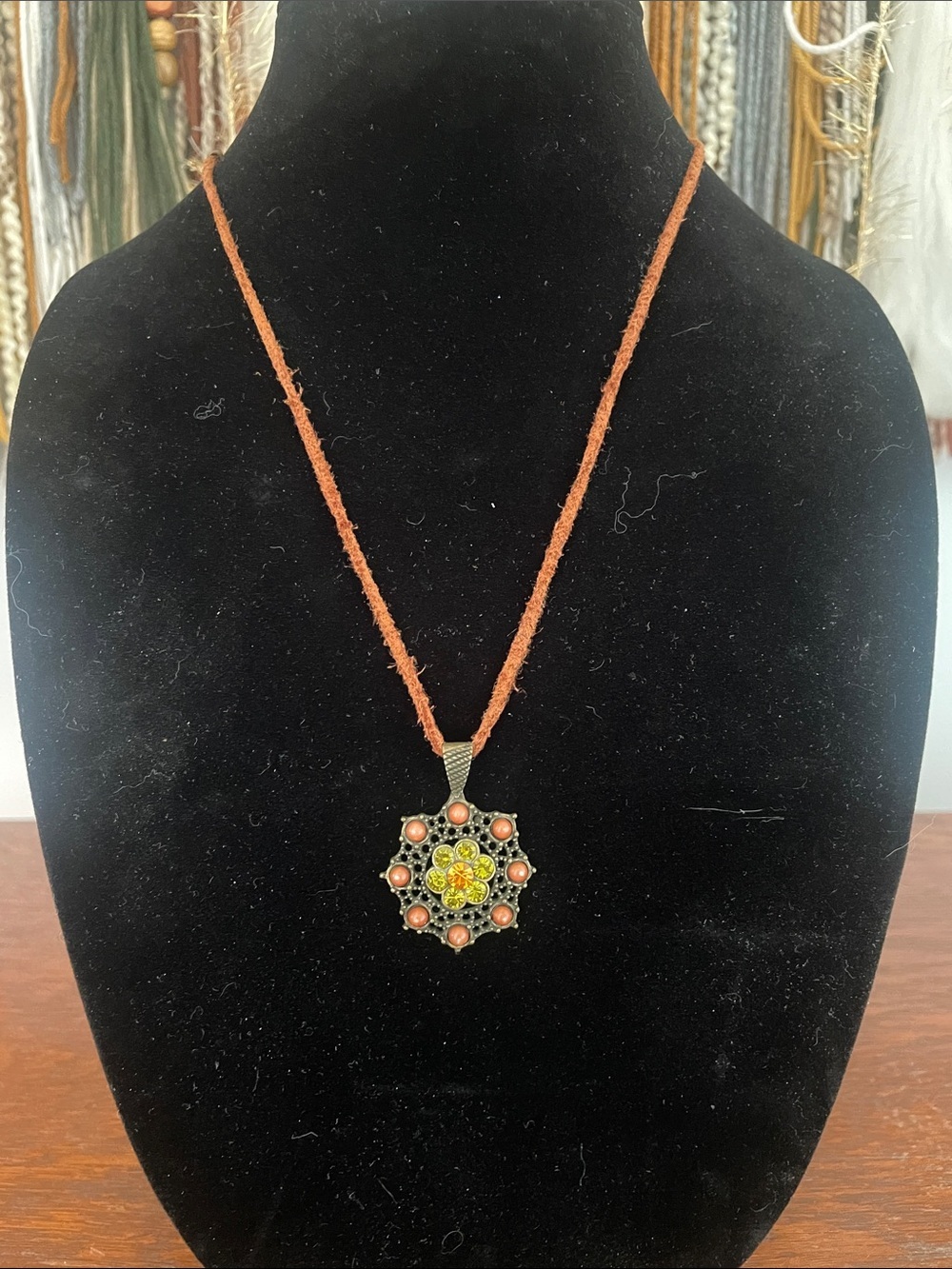 Rustic look pendant on leather chord necklace with green stones